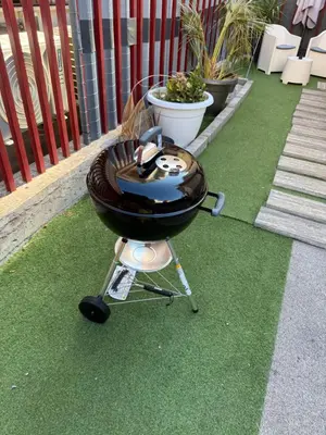 a bbq grill sitting on top of the grass at Zisa Private House in Palermo