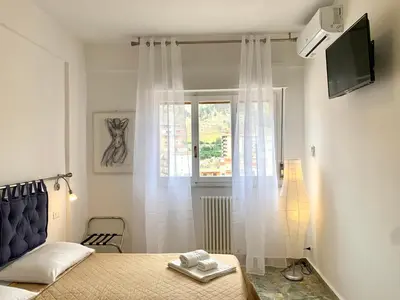 a bedroom with a bed and a window at A Casa di Giovi in Palermo