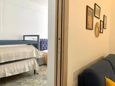 a bedroom with a bed and a couch at A Casa di Giovi in Palermo