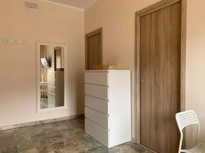 a room with a white refrigerator and a mirror at A Casa di Giovi in Palermo