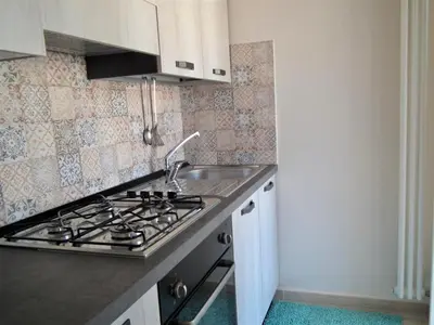 a kitchen with a sink and a stove at A Casa di Giovi in Palermo