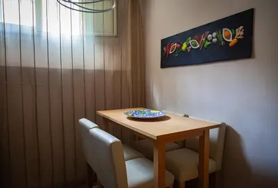 a wooden table with two chairs and a plate on it at vivà house in Palermo