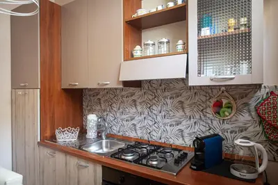 a kitchen with a sink and a stove top oven at vivà house in Palermo