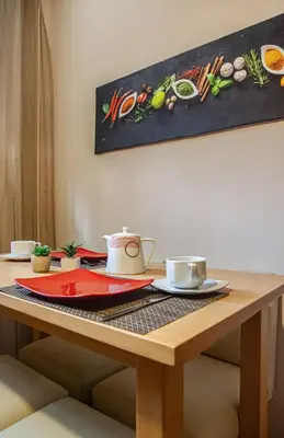 a wooden table with two cups and plates on it at vivà house in Palermo