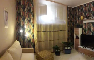 a living room with a couch and a television at vivà house in Palermo