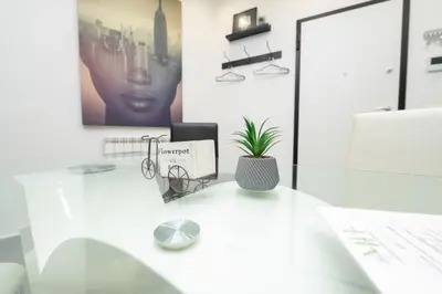 a white desk with a potted plant on it at Modern House Orleans in Palermo