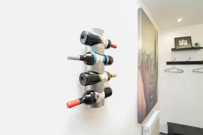 a wine bottle rack on the wall in a room at Modern House Orleans in Palermo