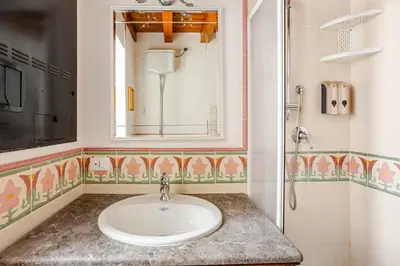 a bathroom with a sink and a mirror at Dimora degli Scalzi - Dive into Palermo's History in Palermo