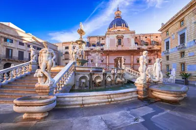 a building with a fountain in front of a building at Dimora degli Scalzi - Dive into Palermo's History in Palermo