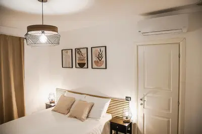 a bedroom with a white bed and a pendant light at SANT'ELIGIO APARTMENTS & ROOMS in Palermo