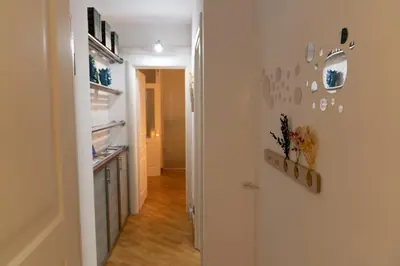 a hallway with a kitchen and a refrigerator at SANT'ELIGIO APARTMENTS & ROOMS in Palermo
