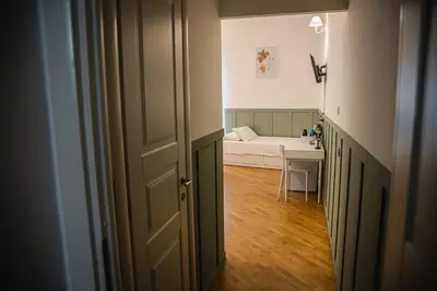 a hallway with a room with a bed and a table at SANT'ELIGIO APARTMENTS & ROOMS in Palermo