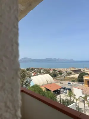 a view from a window of a city and the ocean at Miramare in Balestrate