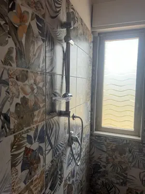 a shower in a bathroom with a window at Miramare in Balestrate