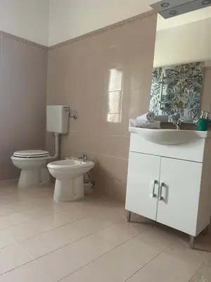 a bathroom with a toilet and a sink at Miramare in Balestrate