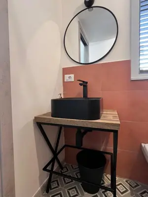 a bathroom with a black sink and a mirror at M'AMA apartment 1 in Ficarazzi