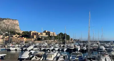a bunch of boats are docked in a harbor at Casa Basile in Palermo