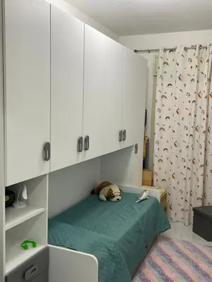 a dog laying on a bed in a room at Casa Basile in Palermo