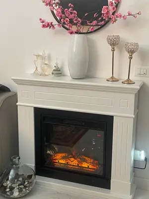 a fireplace with a white mantle with a fire place at Casa Basile in Palermo