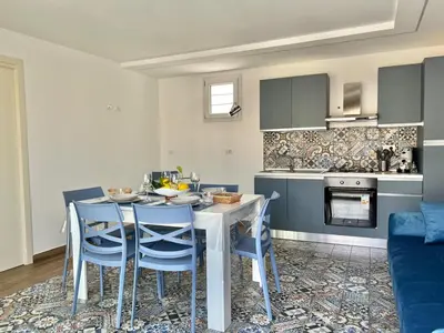 a kitchen and dining room with a table and chairs at M'AMA apartment 2 in Ficarazzi