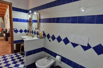 a bathroom with a toilet and a sink and a mirror at home indipendenza 2 in Palermo