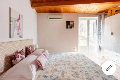 a bedroom with a large bed with a wooden ceiling at home indipendenza 2 in Palermo
