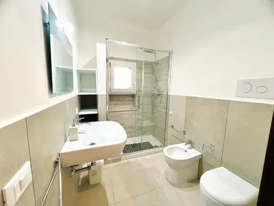 a bathroom with a sink and a toilet and a shower at L'Angolo del Saraceno in Carini