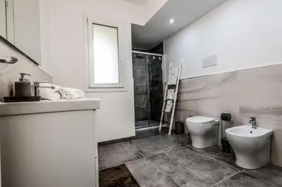 a bathroom with a sink and a toilet at King's house apartments in Palermo