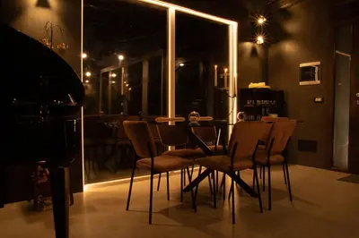 a dining room with a table and chairs at night at Spera Luxury in Monreale