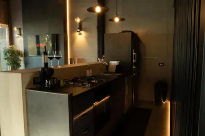 a kitchen with a stove and a sink and a refrigerator at Spera Luxury in Monreale