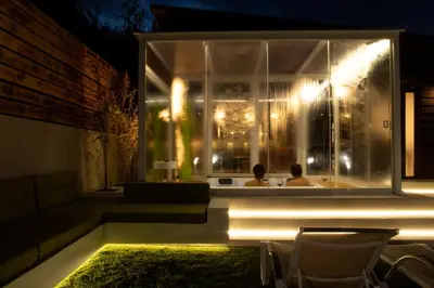 a couple in a bath tub in a window at night at Spera Luxury in Monreale