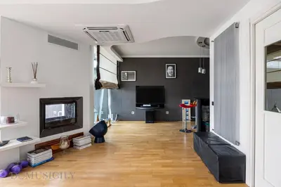 a living room with a couch and a television at Villa Maurino by DomuSicily in Mondello