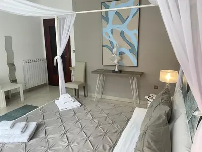 a bedroom with a bed and a table with a lamp at Al Politeama Rooms B&B in Palermo