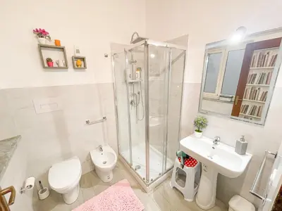 a bathroom with a shower and a toilet and a sink at Al Politeama Rooms B&B in Palermo