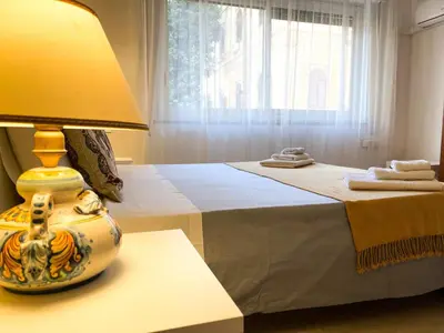 a bedroom with a bed with a lamp on a table at Al Politeama Rooms B&B in Palermo