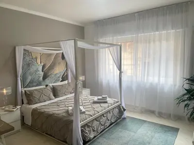 a bedroom with a canopy bed and a window at Al Politeama Rooms B&B in Palermo