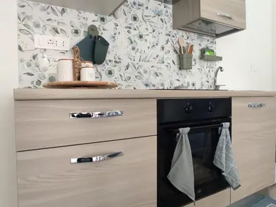 a kitchen with a stove with towels hanging on it at Mondello Villetta Giusi in Mondello