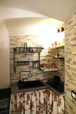 a kitchen with a sink and a counter top at Lo scarrozzo room in Palermo