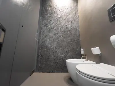 a bathroom with a white toilet and a shower at Platinum Suite&Spa in Palermo