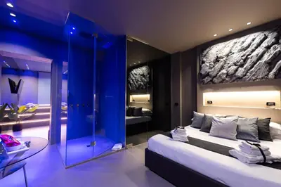 a bedroom with a large bed and a blue wall at Platinum Suite&Spa in Palermo
