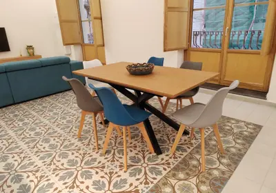 a dining room with a table and chairs at Ciuririvù in Palermo