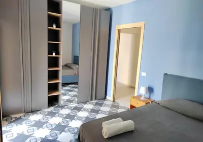 a bedroom with a bed and a checkerboard floor at Ciuririvù in Palermo