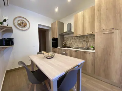 a room with two beds and a white wall at Casetta al Molo Trapezoidale in Palermo