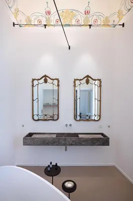 two mirrors on a wall above a bathroom sink at Piano Alloro in Palermo
