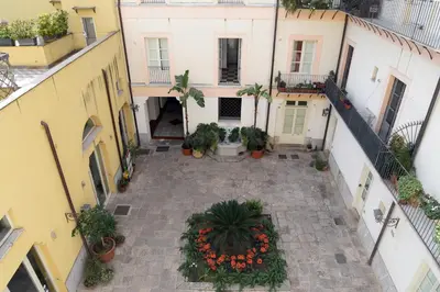 an empty courtyard in a building with plants at Piano Alloro in Palermo
