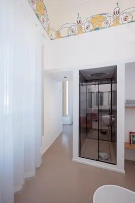 a room with white walls and a mirror at Piano Alloro in Palermo