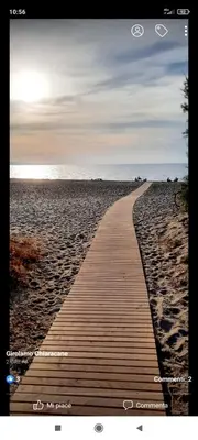 a boardwalk leading to the ocean on a beach at Casa al mare in Lascari