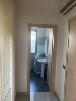 a bathroom with a sink and a mirror and a toilet at Casa al mare in Lascari