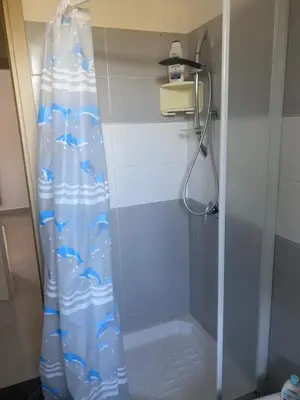 a shower with a blue shower curtain in a bathroom at Casa al mare in Lascari