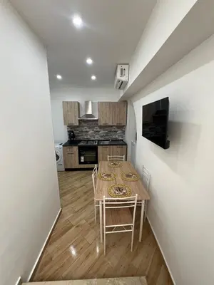 a kitchen with a table and chairs in a room at Incanto di luna Apartment in Palermo
